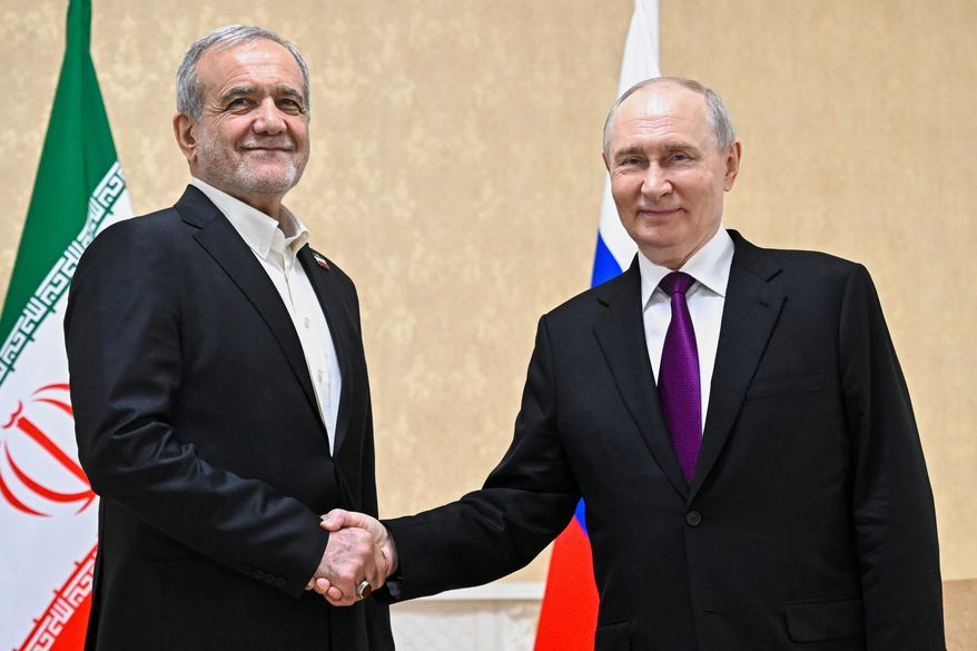Russian President Vladimir Putin, right, and Iranian President Masoud Pezeshkian pose for a photo on the sidelines of the Commonwealth of Independent States (CIS) summit in Turkmenistan, Thursday, Oct. 8, 2026. (Sergei Bobylev, Sputnik, Kremlin Pool Photo via AP)