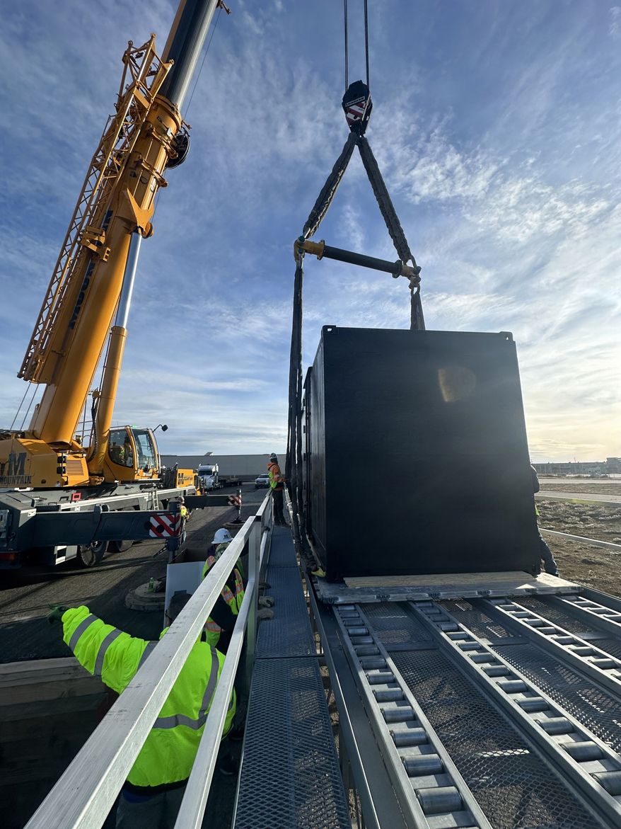 Crews unload containerized nuclear power reactor at Hill Air Force Base, Utah, Feb. 15, 2026. The system is part of an interagency demonstration evaluating the feasibility of rapidly deploying nuclear power using strategic airlift. (Courtesy photo by Tech. Sgt. William McCalmant)