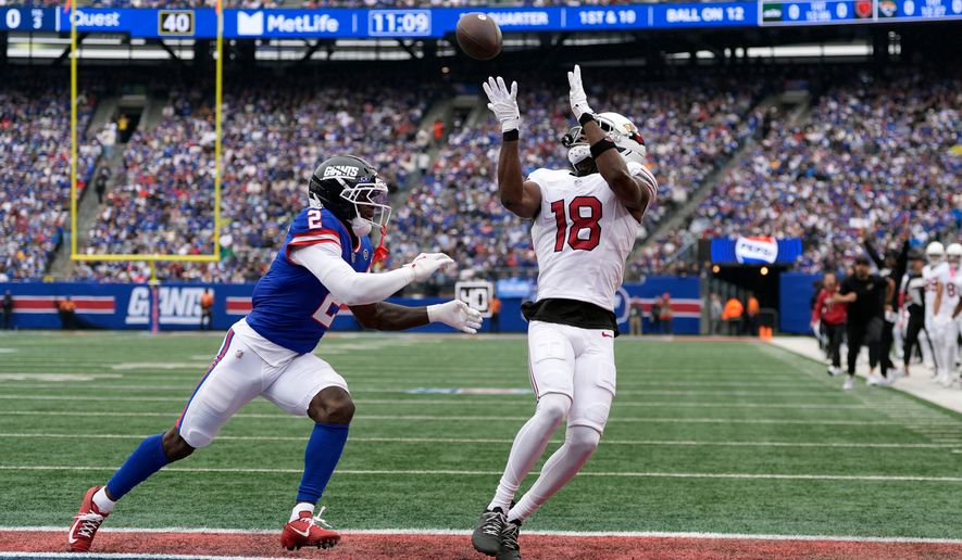 Arizona Cardinals wide receiver Marvin Harrison Jr. (18) makes a touchdown catch against New York Giants cornerback Deonte Banks (2) during an NFL football game, in East Rutherford, N.J., Sunday, Oct. 4, 2026. (AP Photo/Seth Wenig)