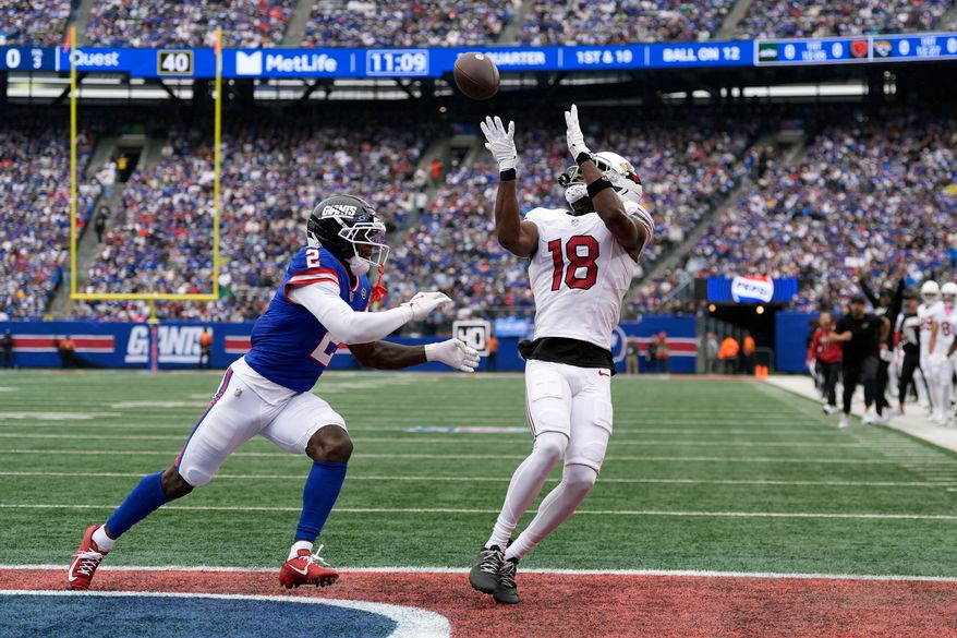Arizona Cardinals wide receiver Marvin Harrison Jr. (18) makes a touchdown catch against New York Giants cornerback Deonte Banks (2) during an NFL football game, in East Rutherford, N.J., Sunday, Oct. 4, 2026. (AP Photo/Seth Wenig)