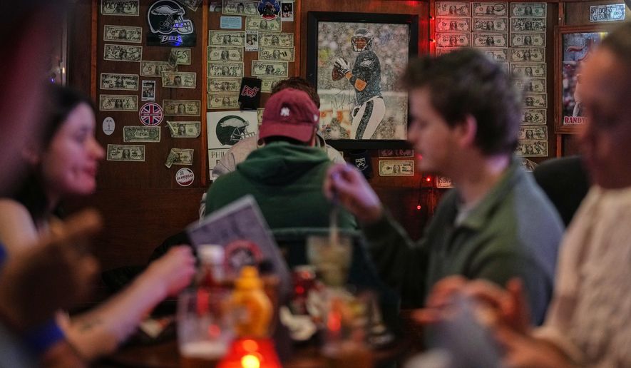 A photo of former Philadelphia Eagles player Nick Foles, who led the team to win its first Super Bowl LII, is displayed on a wall at Passyunk Avenue bar in London, Wednesday, Oct. 7, 2026. (AP Photo/Alastair Grant)
