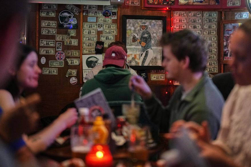 A photo of former Philadelphia Eagles player Nick Foles, who led the team to win its first Super Bowl LII, is displayed on a wall at Passyunk Avenue bar in London, Wednesday, Oct. 7, 2026. (AP Photo/Alastair Grant)