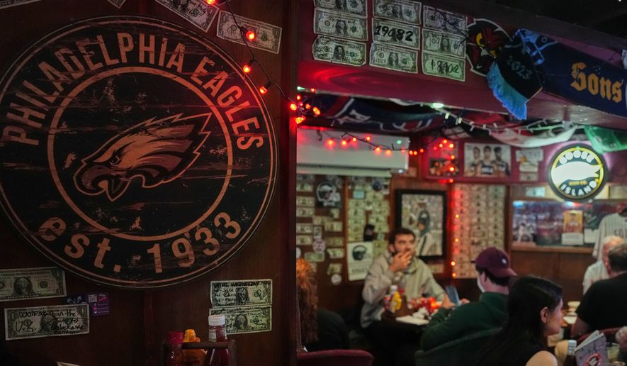 A Philadelphia Eagles emblem is displayed on a wall at the Passyunk Avenue bar in London, Wednesday, Oct. 7, 2026. (AP Photo/Alastair Grant)