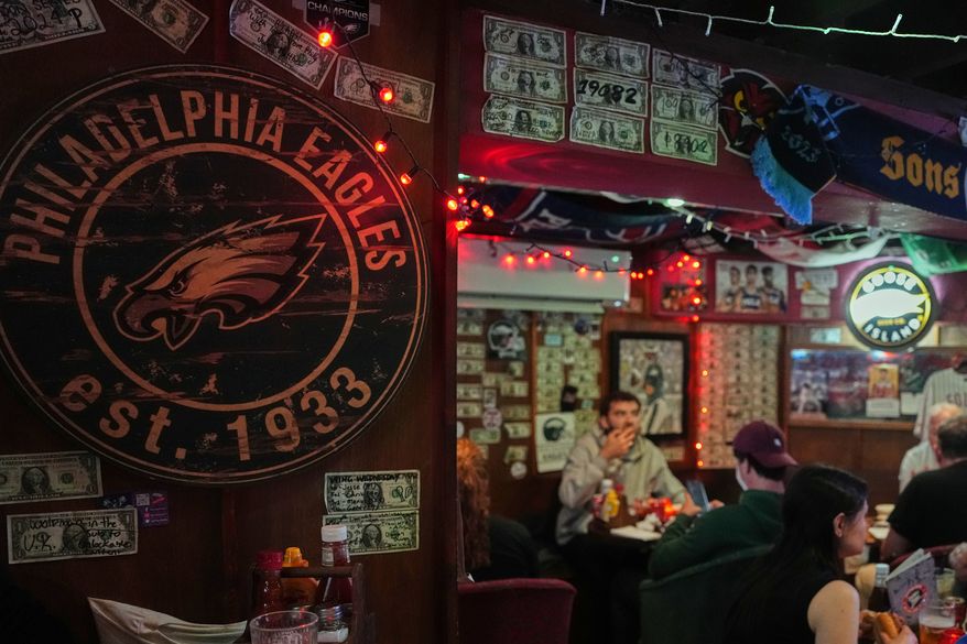 A Philadelphia Eagles emblem is displayed on a wall at the Passyunk Avenue bar in London, Wednesday, Oct. 7, 2026. (AP Photo/Alastair Grant)