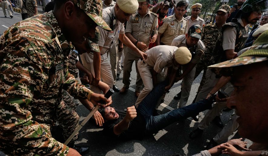 Police detain protesters during a demonstration demanding the resignation of Chief Election Commissioner Gyanesh Kumar in New Delhi, India, Saturday, Oct. 10, 2026.(AP Photo/Manish Swarup)