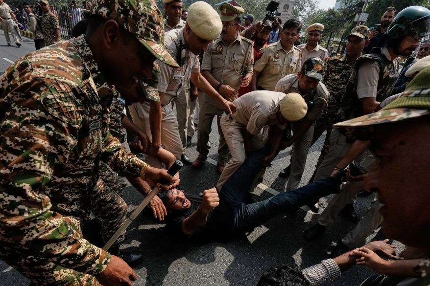 Police detain protesters during a demonstration demanding the resignation of Chief Election Commissioner Gyanesh Kumar in New Delhi, India, Saturday, Oct. 10, 2026.(AP Photo/Manish Swarup)