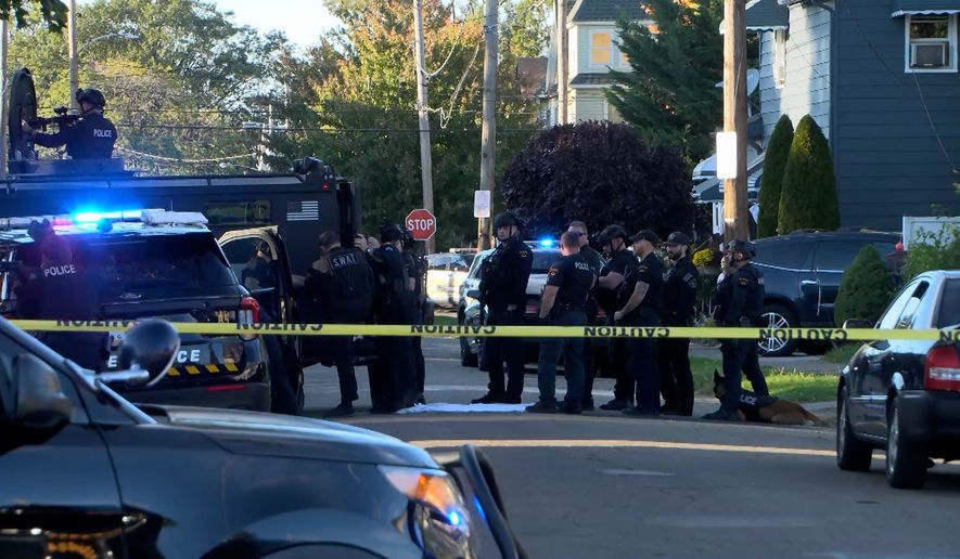 In this image from video provided by WJET, police gather outside the scene of a shooting in Erie, Pa., on Friday evening, Oct. 9, 2026. (Matt Barnum/WJET via AP)
