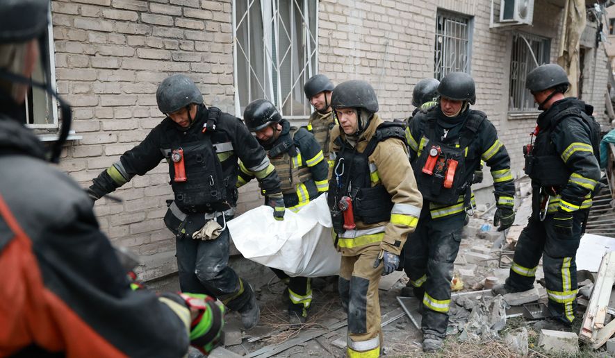 Rescue workers carry a body after pulling from the rubble of a residential building destroyed by a Russian airstrike in Zaporizhzhia, Ukraine, Saturday, Oct. 10, 2026. (AP Photo/Kateryna Klochko)