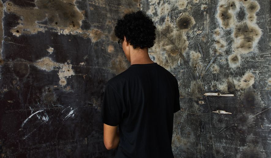 A 17-year-old aspiring model from northern Morocco, who did not want his name used because he was unaccompanied and feared for his safety, poses for a photograph during an interview near El Trampolín Beach in the Spanish enclave of Ceuta, Wednesday, Sept. 30, 2026. (AP Photo/Bernat Armangue)