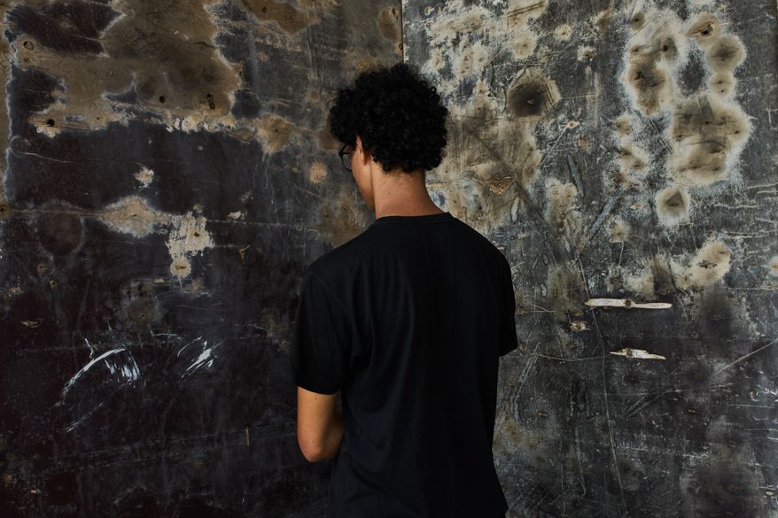 A 17-year-old aspiring model from northern Morocco, who did not want his name used because he was unaccompanied and feared for his safety, poses for a photograph during an interview near El Trampolín Beach in the Spanish enclave of Ceuta, Wednesday, Sept. 30, 2026. (AP Photo/Bernat Armangue)