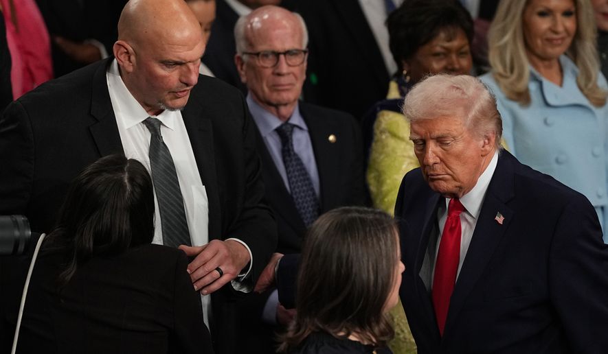 FILE - President Donald Trump passes Sen. John Fetterman, D-Pa., as he departs after delivering the State of the Union address to a joint session of Congress in the House chamber at the U.S. Capitol in Washington, Tuesday, Feb. 24, 2026. (AP Photo/Matt Rourke,File)