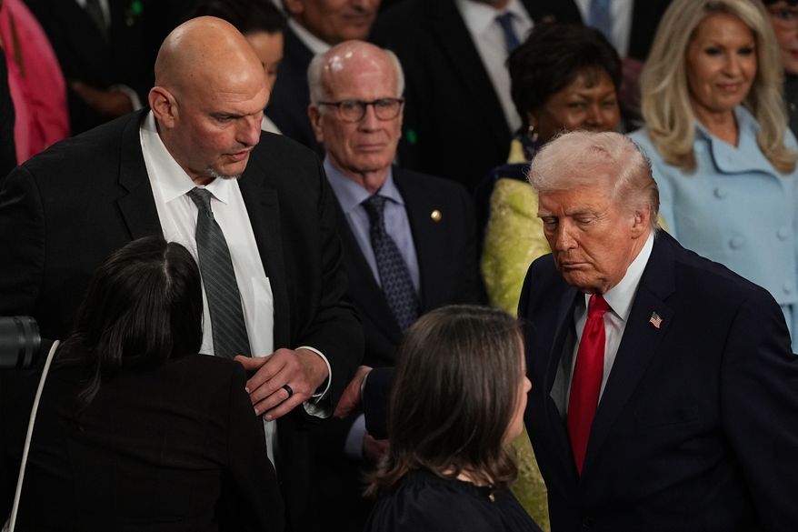 FILE - President Donald Trump passes Sen. John Fetterman, D-Pa., as he departs after delivering the State of the Union address to a joint session of Congress in the House chamber at the U.S. Capitol in Washington, Tuesday, Feb. 24, 2026. (AP Photo/Matt Rourke,File)