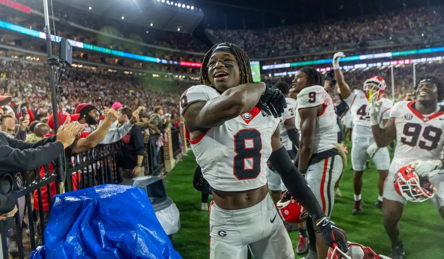 Georgia defensive back Demello Jones (8) celebrates with the fans as the final seconds wind off the clock in a win over Alabama during the second half of an NCAA college football game Saturday, Oct. 10, 2026, in Tuscaloosa, Ala. (AP Photo/Vasha Hunt)