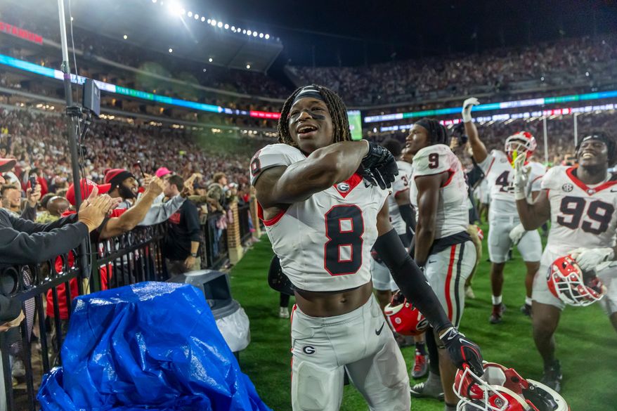 Georgia defensive back Demello Jones (8) celebrates with the fans as the final seconds wind off the clock in a win over Alabama during the second half of an NCAA college football game Saturday, Oct. 10, 2026, in Tuscaloosa, Ala. (AP Photo/Vasha Hunt)