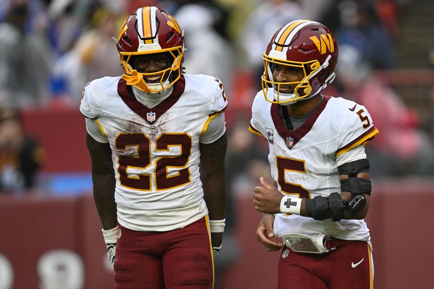 Washington Commanders running back Jacory Croskey-Merritt (22) celebrates with quarterback Jayden Daniels (5) after the quarterback’s 38-yard touchdown run against the New York Giants at Northwest Stadium in Landover, Maryland, October 11, 2026. (Photo by Brian Murphy for the Washington Times)