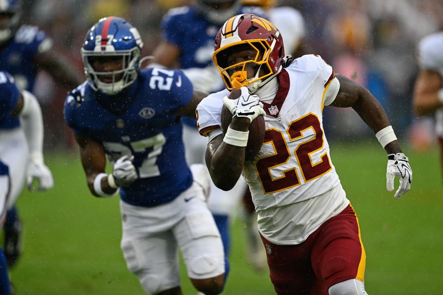 Washington Commanders running back Jacory Croskey-Merritt (22) sprints past New York Giants safety Tyler Rubin (27) en route to the end zone for a 33-yard touchdown at Northwest Stadium in Landover, Maryland, October 11, 2026. (Photo by Brian Murphy for the Washington Times)
