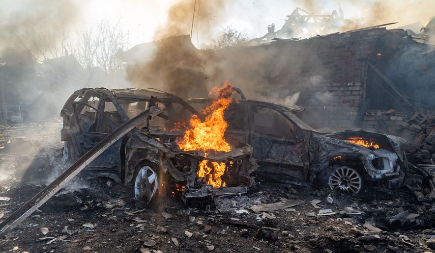 Cars burn after a Russian strike on a residential neighbourhood in Kharkiv, Ukraine, Sunday, Oct. 11, 2026. (AP Photo/Andrii Marienko)