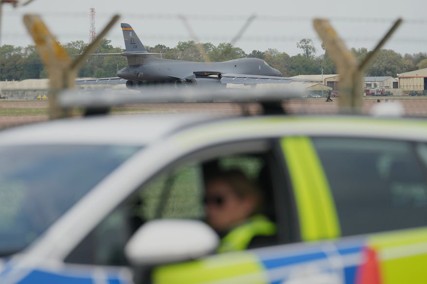 A B1 bomber prepares to take off as police officers guard a checkpoint near RAF Fairford air base, in Fairford, England, Tuesday, Sept. 29, 2026. (AP Photo/Alastair Grant, File)