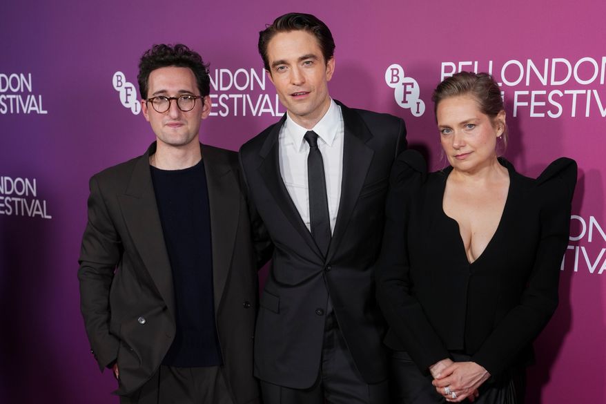 Director Lance Oppenheim, from left, Robert Pattinson and Merritt Wever pose for photographers upon arrival at the premiere for the film "Primetime" as part of the London film festival in London, Sunday, Oct. 11, 2026. (Photo by Scott A Garfitt/Invision/AP)