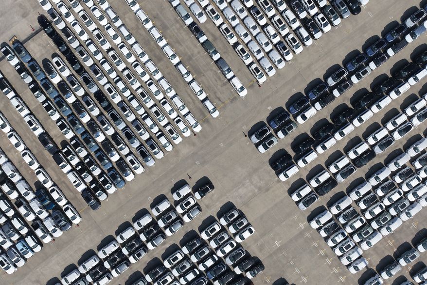 FILE - An aerial view of new cars awaiting export to oversea markets is seen at a port in Shanghai, March 10, 2026. (Chinatopix via AP, File)