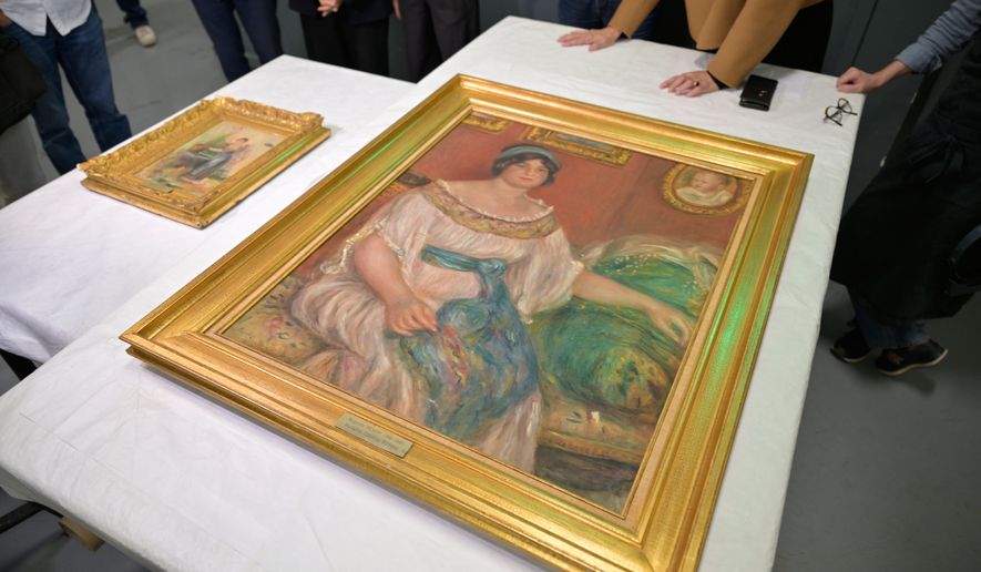 Recovered paintings "Portrait of Madame Colonna Romano", right, and "Young Woman at the Well," stolen from the Renoir Museum in Cagnes-sur-Mer are on display at the Interdisciplinary Centre for the Conservation and Restoration of Heritage in Marseille, France, Monday Oct. 12, 2026. (AP Photo/Philippe Magoni)