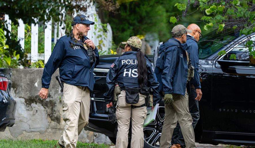 Homeland Security officers leave the Washington residence of Rep. Ilhan Omar, D-Minn., after a search, Monday, Oct. 12, 2026. (AP Photo/J. Scott Applewhite)