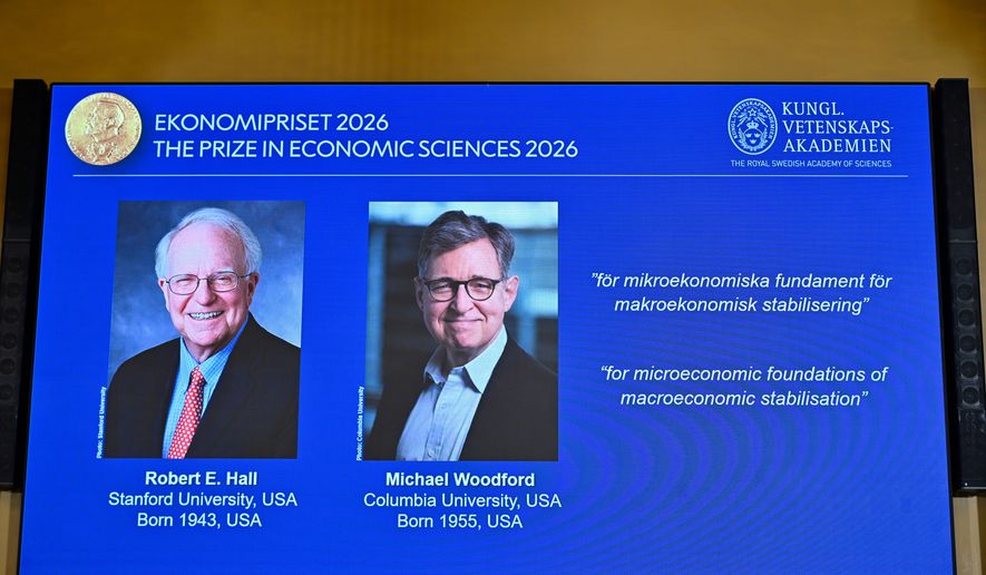 Portraits of Robert E. Hall and Michael Woodford are shown on the screen as they are announced as the laureates of the Sveriges Riksbank Prize in Economic Sciences in Memory of Alfred Nobel at the Royal Swedish Academy of Sciences in Stockholm, Sweden, Monday, Oct. 12, 2026. (Anders Wiklund/TT News Agency via AP)