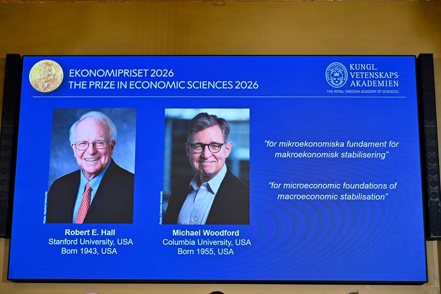 Portraits of Robert E. Hall and Michael Woodford are shown on the screen as they are announced as the laureates of the Sveriges Riksbank Prize in Economic Sciences in Memory of Alfred Nobel at the Royal Swedish Academy of Sciences in Stockholm, Sweden, Monday, Oct. 12, 2026. (Anders Wiklund/TT News Agency via AP)
