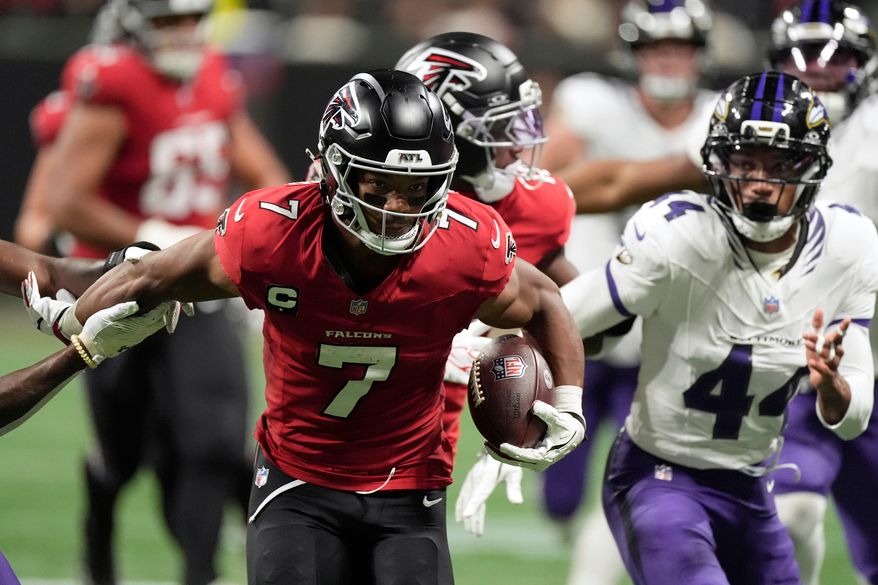 Atlanta Falcons running back Bijan Robinson (7) runs from Baltimore Ravens cornerback Marlon Humphrey (44) during the second half of an NFL football game, Sunday, Oct. 11, 2026, in Atlanta. (AP Photo/Mike Stewart)