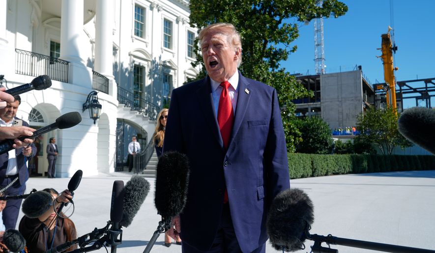 President Donald Trump talks to reporters before boarding Marine One on the South Lawn of the White House, Tuesday, Oct. 13, 2026, in Washington. (AP Photo/Manuel Balce Ceneta)