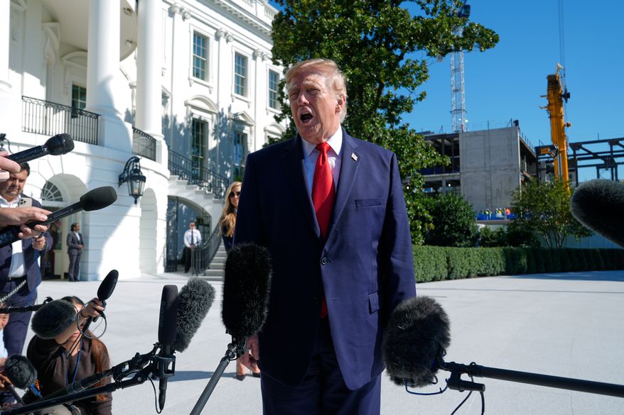 President Donald Trump talks to reporters before boarding Marine One on the South Lawn of the White House, Tuesday, Oct. 13, 2026, in Washington. (AP Photo/Manuel Balce Ceneta)