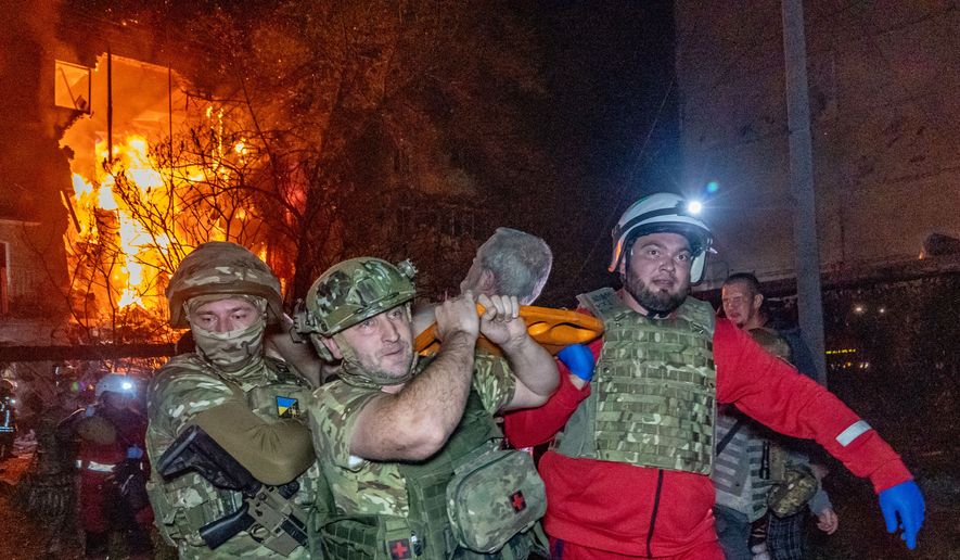 Rescuers evacuate an injured civilian after a residential building was hit following a Russian air attack in Kharkiv, Ukraine, Tuesday, Oct. 13, 2026. (AP Photo/Andrii Marienko)