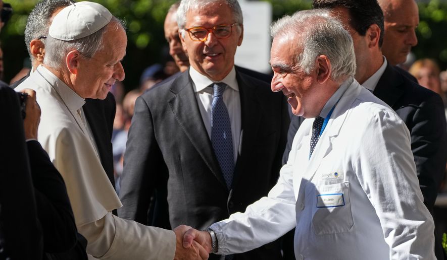 Medical Director Andrea Cambieri, right, greets Pope Leo XIV as he arrives at the Agostino Gemelli Polyclinic in Rome on Tuesday, Oct. 13, 2026, where doctors expect to operate to remove a lung nodule. (AP Photo/Gregorio Borgia)
