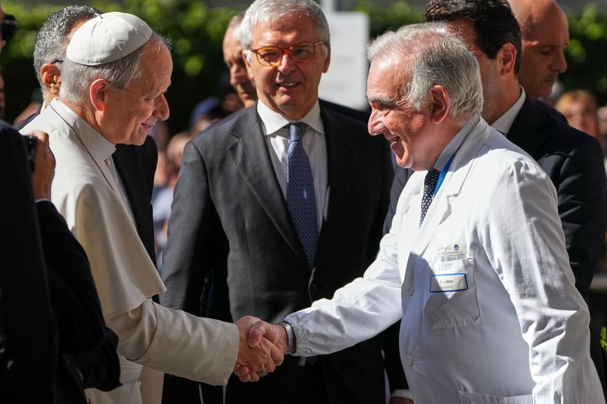 Medical Director Andrea Cambieri, right, greets Pope Leo XIV as he arrives at the Agostino Gemelli Polyclinic in Rome on Tuesday, Oct. 13, 2026, where doctors expect to operate to remove a lung nodule. (AP Photo/Gregorio Borgia)
