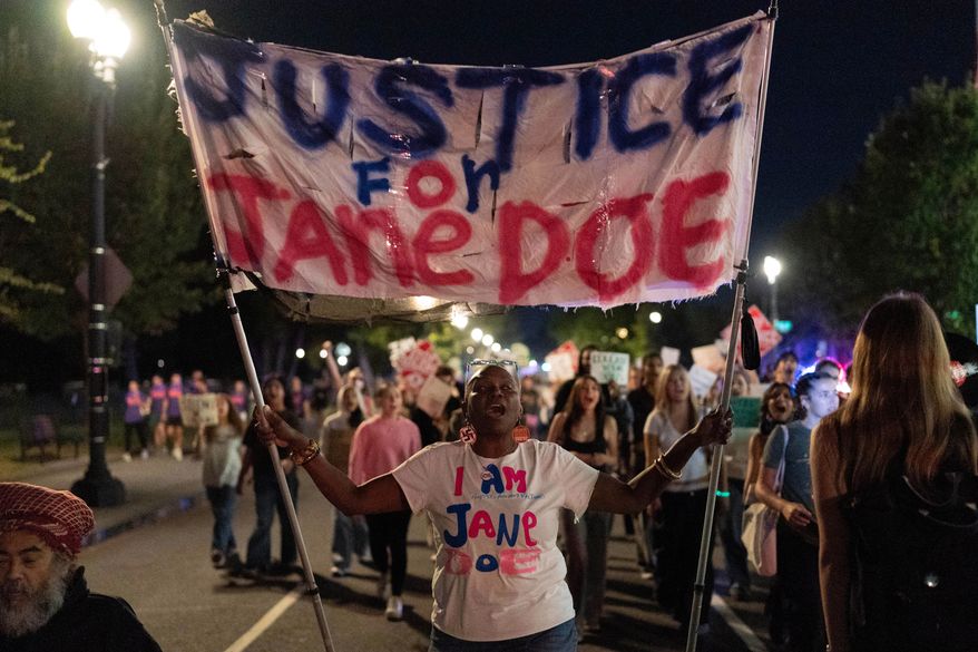 Demonstrators march from the Washington Monument to the White House during a "Stop Sexual Violence" protest in Washington, Thursday, Oct. 8, 2026. (AP Photo/Jose Luis Magana)