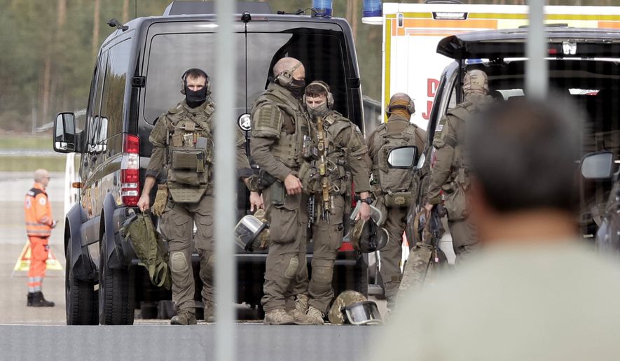 Members of a Police special operations unit (SEK) are on the move within the Nuremberg airport grounds in Nuremberg, Germany, Tuesday, Oct. 13, 2026. (Tizian Gerbing/dpa via AP)