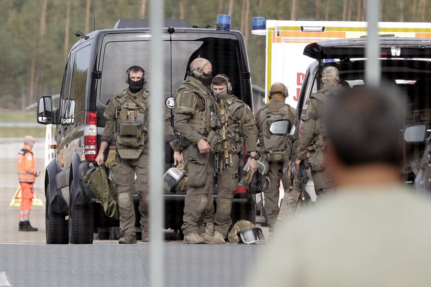 Members of a Police special operations unit (SEK) are on the move within the Nuremberg airport grounds in Nuremberg, Germany, Tuesday, Oct. 13, 2026. (Tizian Gerbing/dpa via AP)