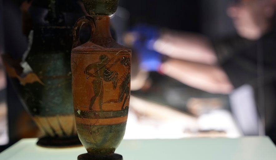 Greek antiquities dating to the 6th and 5th centuries B.C. are displayed during a repatriation ceremony at the National Archaeological Museum in Athens, Greece, Tuesday, Oct. 13, 2026, after 22 artifacts illegally removed from Greece were returned by Israel. (AP Photo/Thanassis Stavrakis)