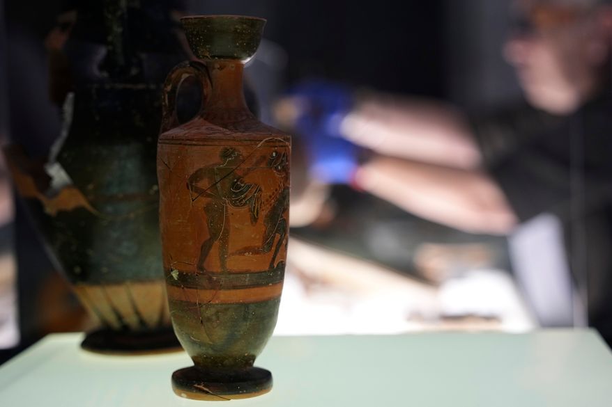 Greek antiquities dating to the 6th and 5th centuries B.C. are displayed during a repatriation ceremony at the National Archaeological Museum in Athens, Greece, Tuesday, Oct. 13, 2026, after 22 artifacts illegally removed from Greece were returned by Israel. (AP Photo/Thanassis Stavrakis)