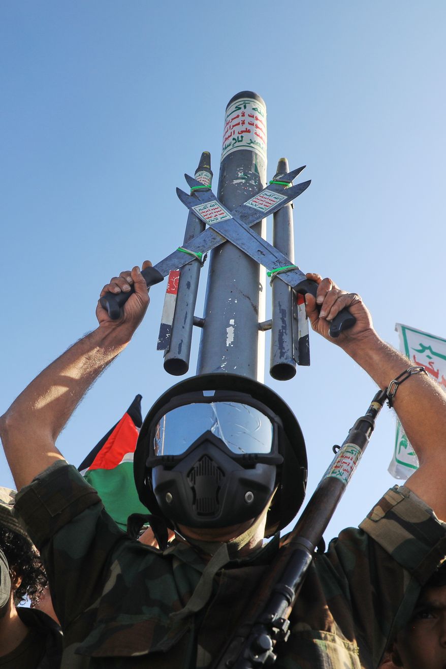 A Houthi supporter wearing a military uniform holds a mock missile during a rally in support of the group, in Sanaa, Yemen, Friday, Oct. 9, 2026. (AP Photo/Osamah Abdulrahman)