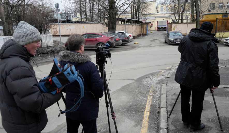 FILE - Journalists stand next to an entrance of the Lefortovo prison, in Moscow, Thursday, March 30, 2023. (AP Photo/Alexander Zemlianichenko, Pool)