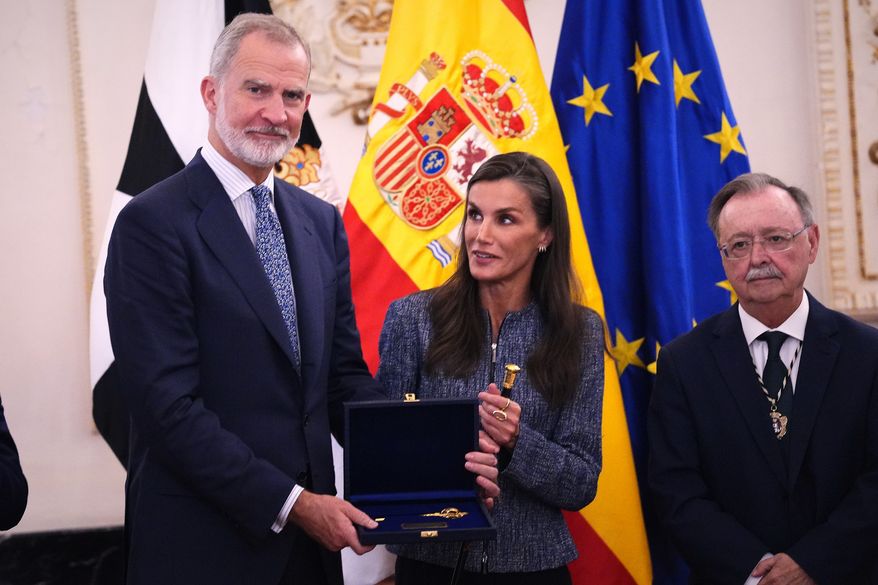 Spain's King Felipe VI and Queen Letizia are presented with the key to the city during their visit to the Spanish enclave of Ceuta, Tuesday, Oct. 13, 2026. (AP Photo/Manu Fernández)