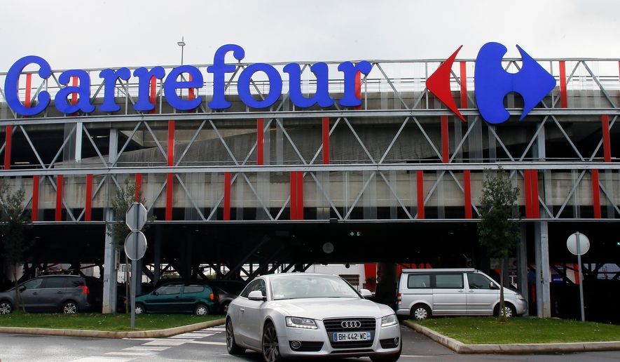 FILE - A car leaves a Carrefour supermarket in Anglet, southwestern France, on Jan. 23, 2018. (AP Photo/Bob Edme, File)