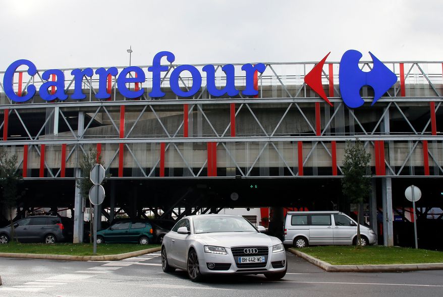 FILE - A car leaves a Carrefour supermarket in Anglet, southwestern France, on Jan. 23, 2018. (AP Photo/Bob Edme, File)