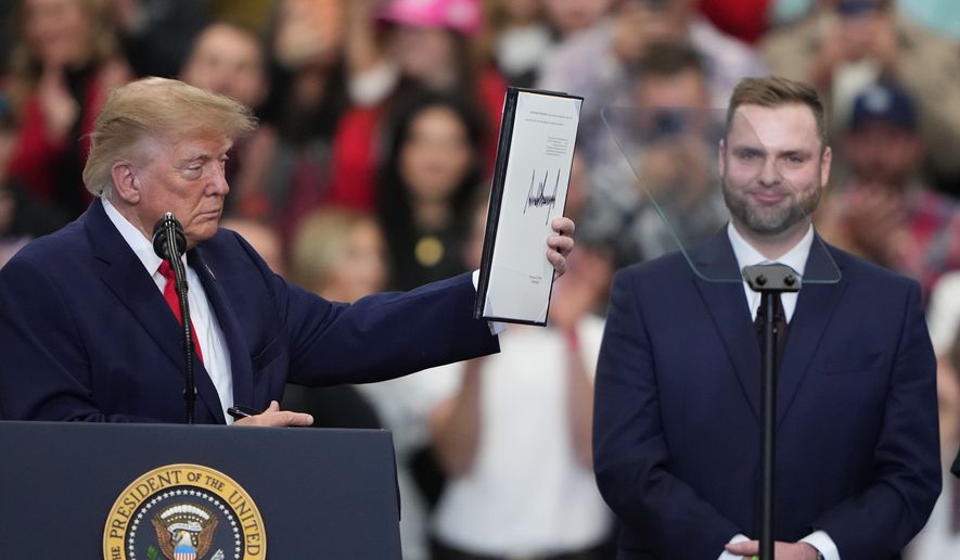 President Donald Trump holds the signed pardon for Patrick Fleming at a campaign rally at the Curtis D. Menard Memorial Sports Center, Tuesday, Oct. 13, 2026, in Wasilla, Alaska. (AP Photo/Lindsey Wasson)