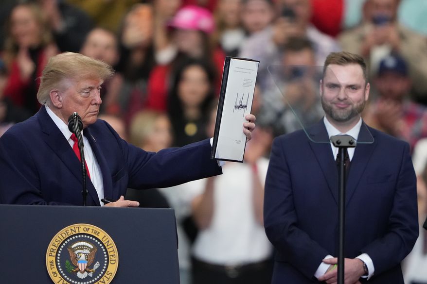 President Donald Trump holds the signed pardon for Patrick Fleming at a campaign rally at the Curtis D. Menard Memorial Sports Center, Tuesday, Oct. 13, 2026, in Wasilla, Alaska. (AP Photo/Lindsey Wasson)