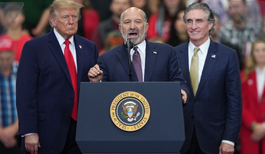President Donald Trump and Interior Secretary Doug Burgum listen as Commerce Secretary Howard Lutnick speaks at a campaign rally at the Curtis D. Menard Memorial Sports Center, Tuesday, Oct. 13, 2026, in Wasilla, Alaska. (AP Photo/Lindsey Wasson)