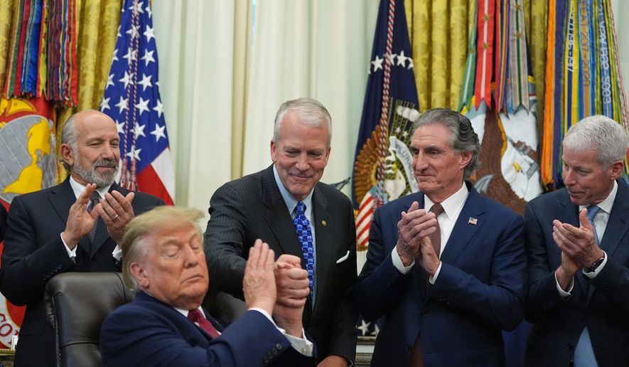 President Donald Trump shakes hands with Sen. Dan Sullivan, R-Alaska, as he speaks in the Oval Office of the White House, Wednesday, Sept. 30, 2026, in Washington, as Commerce Secretary Howard Lutnick, Interior Secretary Doug Burgum and Energy Secretary Chris Wright applaud. (AP Photo/Alex Brandon)