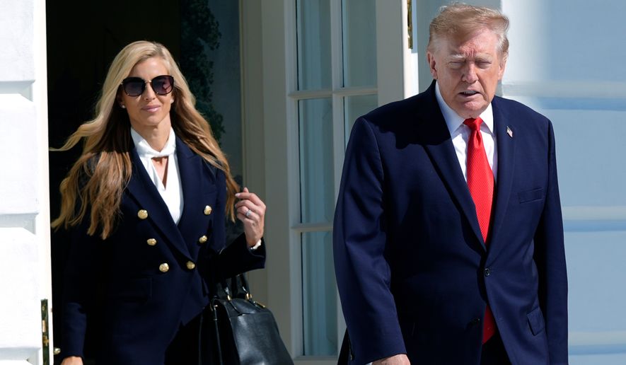 President Donald Trump walks out along with White House press secretary Katie Zacharia to talk to reporters before boarding Marine One on the South Lawn of the White House, Tuesday, Oct. 13, 2026, in Washington. (AP Photo/Manuel Balce Ceneta)
