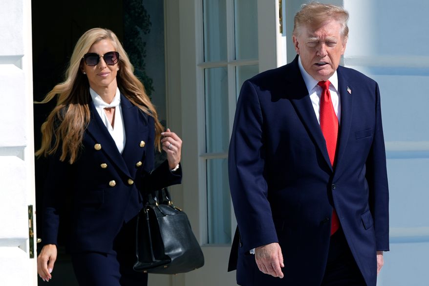 President Donald Trump walks out along with White House press secretary Katie Zacharia to talk to reporters before boarding Marine One on the South Lawn of the White House, Tuesday, Oct. 13, 2026, in Washington. (AP Photo/Manuel Balce Ceneta)